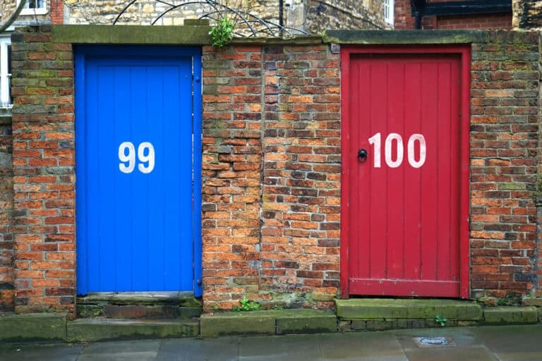 Vibrant red and blue doors in a rustic brick wall, perfect for architectural themes.